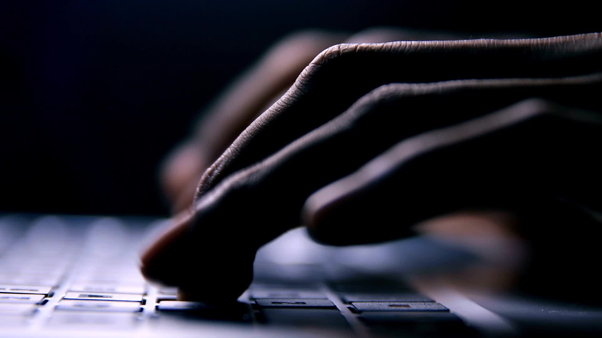 Person typing on laptop keyboard